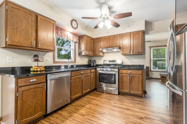 2975 Partridge Ct, Aurora, IL 60502 - kitchen with appliances with stainless steel finishes, a sink, under cabinet range hood, a ceiling fan, and light wood finished floors