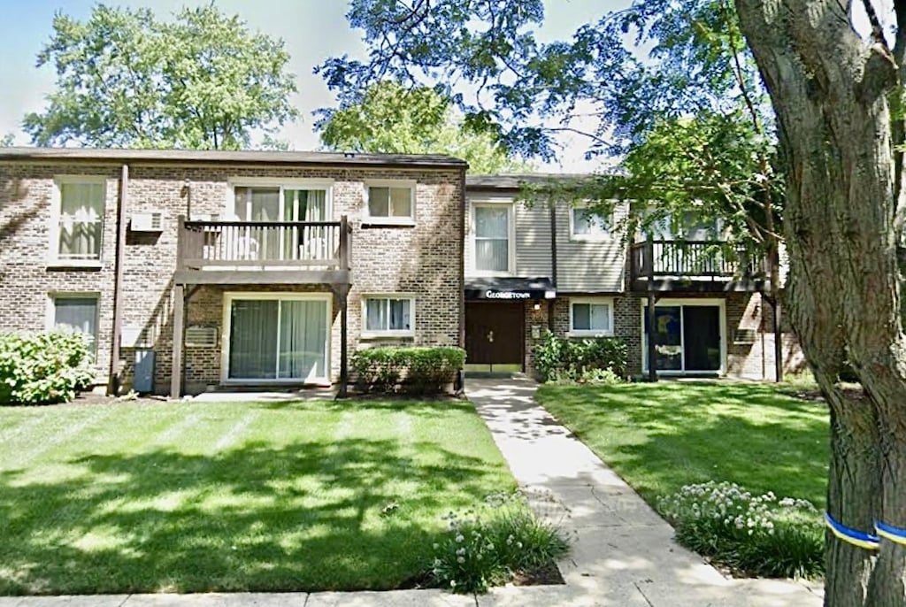 301 N Carter St Unit 102, Palatine, IL 60067 - multi unit property featuring a front yard, brick siding, and a balcony