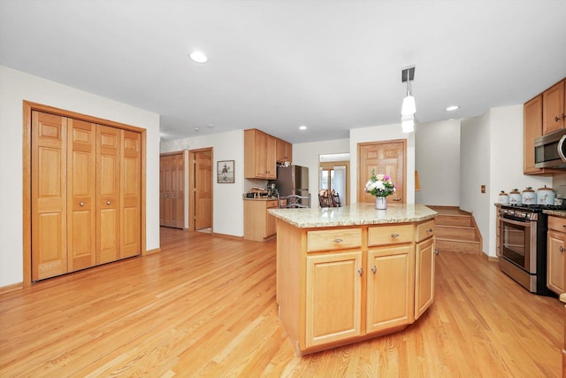 22314 Jeanette Ct, Frankfort, IL 60423 - kitchen with stainless steel appliances, light wood-style floors, a kitchen island, light stone countertops, and hanging light fixtures