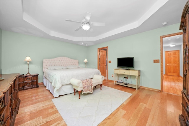 22314 Jeanette Ct, Frankfort, IL 60423 - bedroom featuring a raised ceiling, light wood-type flooring, a ceiling fan, and baseboards