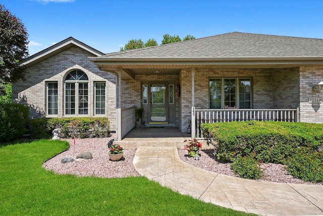 22314 Jeanette Ct, Frankfort, IL 60423 - property entrance featuring brick siding, a porch, a lawn, and a shingled roof