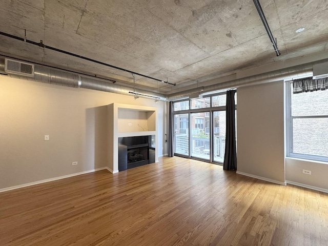 933 W Van Buren St Unit 424, Chicago, IL 60607 - unfurnished living room featuring wood finished floors and a fireplace