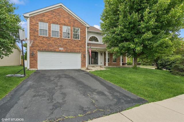 2136 Colonial St, Aurora, IL 60503 - traditional home featuring brick siding, asphalt driveway, a front yard, and a garage