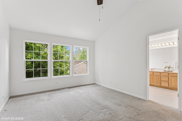 2136 Colonial St, Aurora, IL 60503 - unfurnished bedroom featuring light carpet, baseboards, vaulted ceiling, connected bathroom, and a ceiling fan