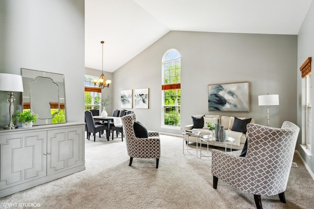 2136 Colonial St, Aurora, IL 60503 - living room featuring light colored carpet, a chandelier, high vaulted ceiling, and plenty of natural light