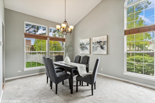 2136 Colonial St, Aurora, IL 60503 - dining room featuring a chandelier, plenty of natural light, baseboards, and high vaulted ceiling