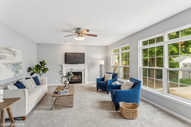 2136 Colonial St, Aurora, IL 60503 - carpeted living area featuring baseboards, a glass covered fireplace, and ceiling fan