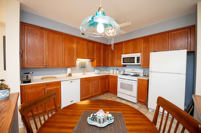 8400 Callie Ave Unit 206, Morton Grove, IL 60053 - kitchen featuring white appliances, a sink, light countertops, and brown cabinetry