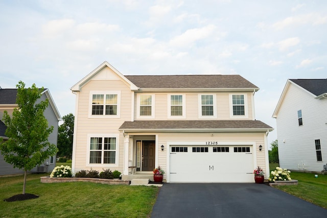 12305 S Prairie Ridge Ln, Plainfield, IL 60585 - traditional home with driveway, a front lawn, and a garage