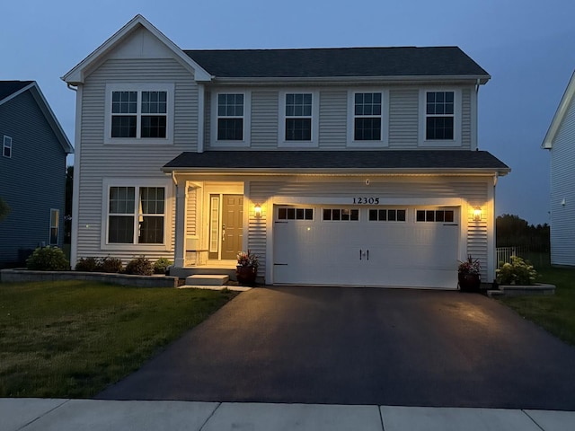 12305 S Prairie Ridge Ln, Plainfield, IL 60585 - traditional-style house with asphalt driveway, an attached garage, and a front lawn