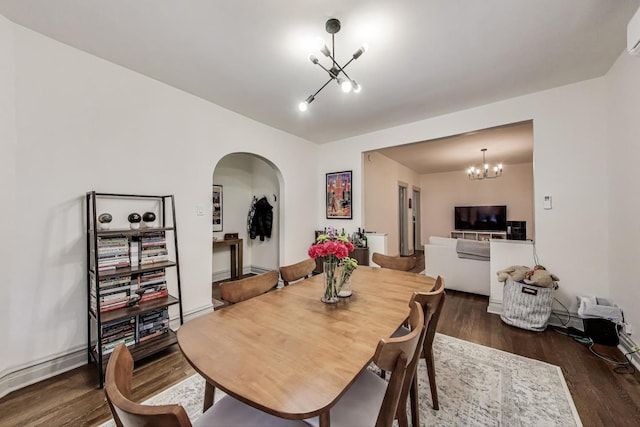 4433 N Artesian Ave, Chicago, IL 60625 - dining room featuring a chandelier, arched walkways, wood finished floors, and a wall mounted AC