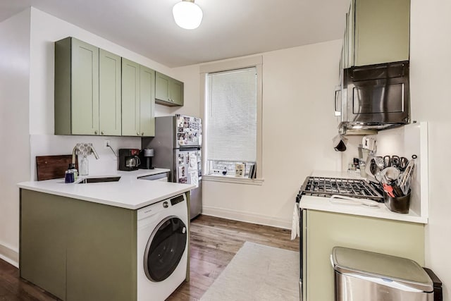 4433 N Artesian Ave, Chicago, IL 60625 - kitchen featuring washer / clothes dryer, green cabinets, black microwave, freestanding refrigerator, and dark wood-type flooring