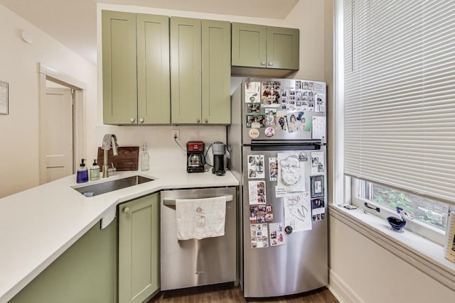 4433 N Artesian Ave, Chicago, IL 60625 - kitchen with green cabinets, stainless steel appliances, a sink, light countertops, and dark wood-style flooring