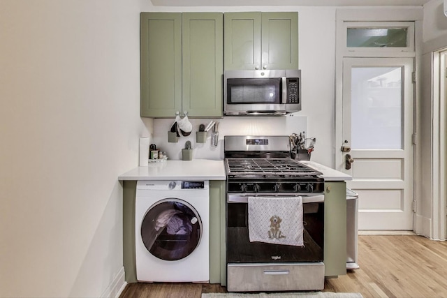 4433 N Artesian Ave, Chicago, IL 60625 - kitchen featuring green cabinetry, washer / dryer, appliances with stainless steel finishes, light wood finished floors, and light countertops