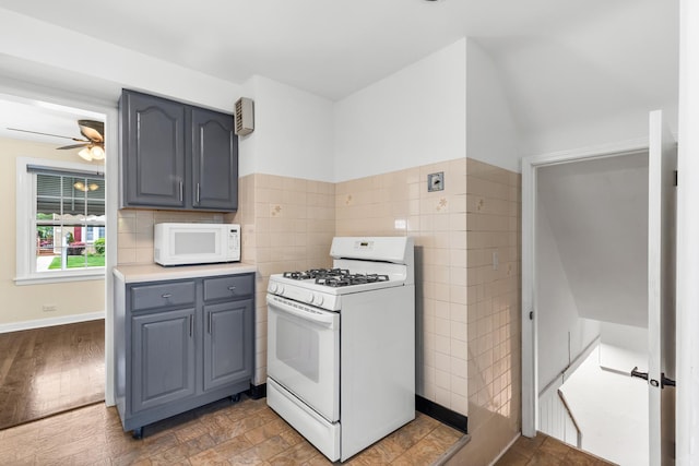 5471 N Octavia Ave, Chicago, IL 60656 - kitchen with white appliances, tile walls, gray cabinetry, ceiling fan, and light countertops