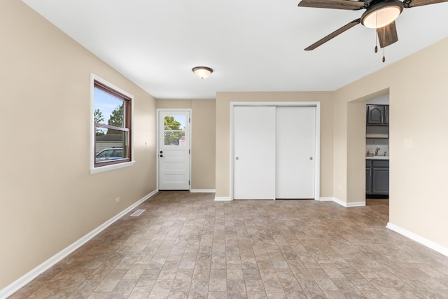 5471 N Octavia Ave, Chicago, IL 60656 - unfurnished bedroom featuring a closet, baseboards, a sink, and ceiling fan