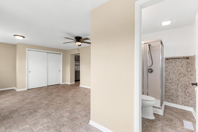 5471 N Octavia Ave, Chicago, IL 60656 - full bathroom featuring toilet, a ceiling fan, a stall shower, and baseboards