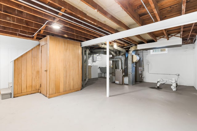5471 N Octavia Ave, Chicago, IL 60656 - basement featuring heating unit, washer / clothes dryer, and gas water heater