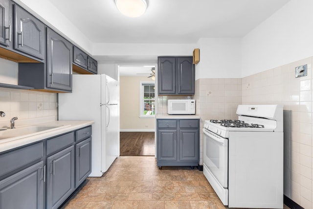 5471 N Octavia Ave, Chicago, IL 60656 - kitchen with white appliances, gray cabinetry, a ceiling fan, light countertops, and a sink