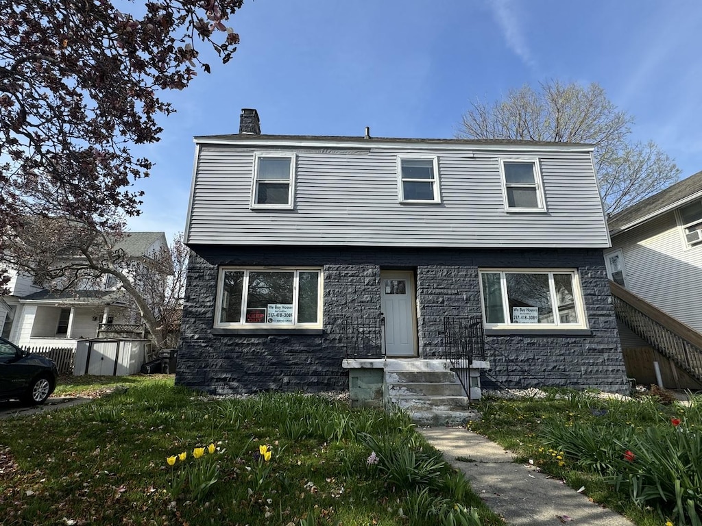 212 W John St, Champaign, IL 61820 - colonial inspired home with a chimney and stone siding