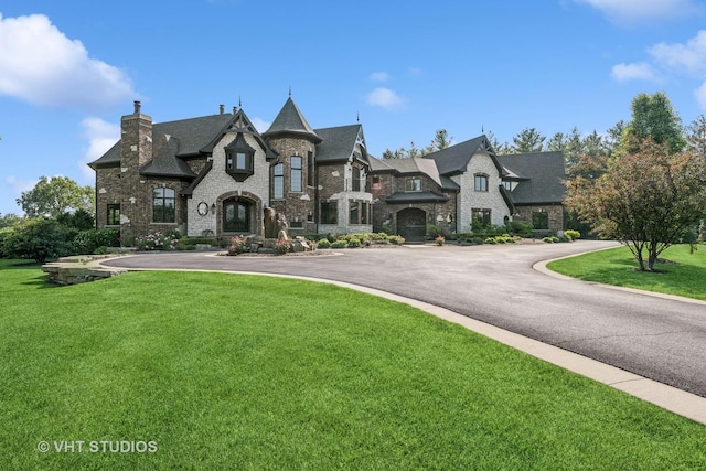 14 Vandenbergh Dr, South Barrington, IL 60010 - french country home with stone siding, a front yard, and a chimney