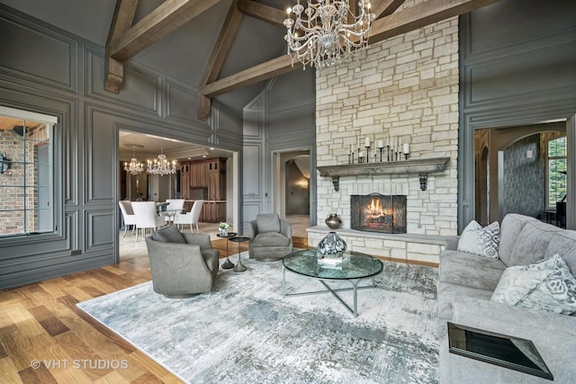 14 Vandenbergh Dr, South Barrington, IL 60010 - living area featuring a chandelier, a fireplace, high vaulted ceiling, a decorative wall, and wood finished floors