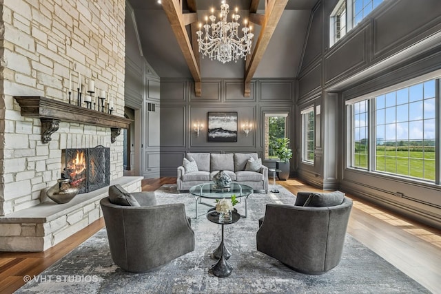 14 Vandenbergh Dr, South Barrington, IL 60010 - living area featuring a decorative wall, a stone fireplace, wood finished floors, a chandelier, and high vaulted ceiling
