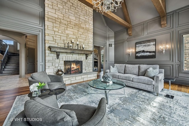 14 Vandenbergh Dr, South Barrington, IL 60010 - living room with a decorative wall, a chandelier, high vaulted ceiling, a stone fireplace, and beam ceiling