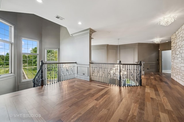 14 Vandenbergh Dr, South Barrington, IL 60010 - spare room featuring a decorative wall, plenty of natural light, wood finished floors, and vaulted ceiling