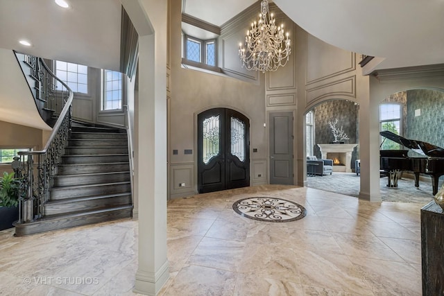 14 Vandenbergh Dr, South Barrington, IL 60010 - foyer featuring arched walkways, marble tiled floors, a high ceiling, stairs, and french doors