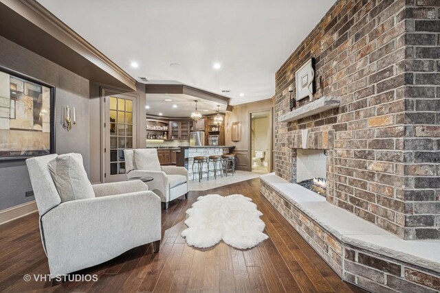 14 Vandenbergh Dr, South Barrington, IL 60010 - living area with ornamental molding, dark wood-style floors, recessed lighting, and a brick fireplace