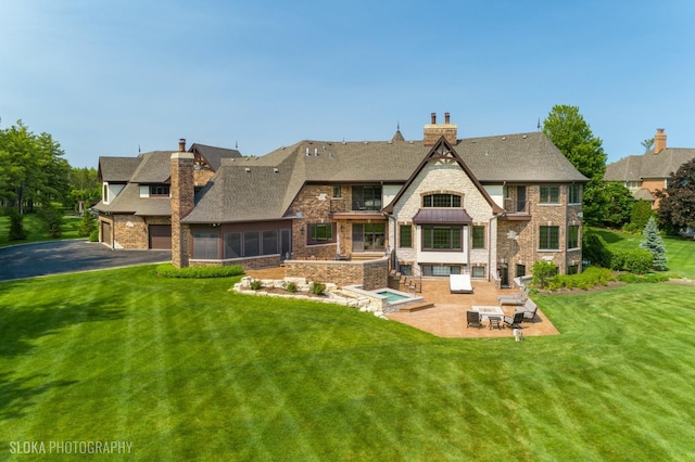 14 Vandenbergh Dr, South Barrington, IL 60010 - back of property featuring a patio area, a chimney, a yard, and roof with shingles