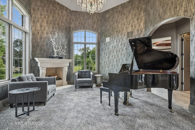 14 Vandenbergh Dr, South Barrington, IL 60010 - sitting room with arched walkways, a chandelier, a fireplace with flush hearth, and carpet floors