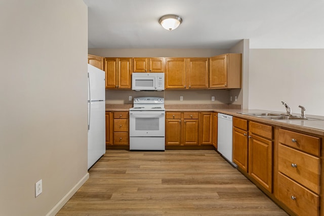 3418 Stoneway Ct, Champaign, IL 61822 - kitchen with white appliances, a sink, light wood-style flooring, brown cabinets, and light countertops