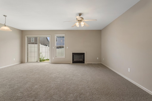 3418 Stoneway Ct, Champaign, IL 61822 - unfurnished living room featuring a ceiling fan, a glass covered fireplace, baseboards, and carpet