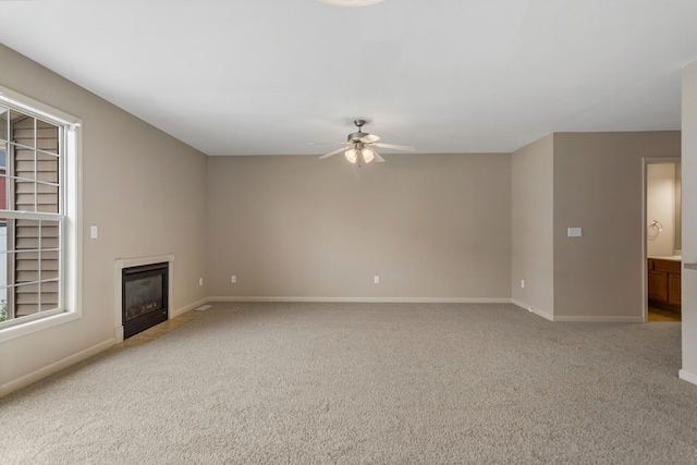 3418 Stoneway Ct, Champaign, IL 61822 - unfurnished living room featuring a ceiling fan, light colored carpet, baseboards, and a fireplace with flush hearth