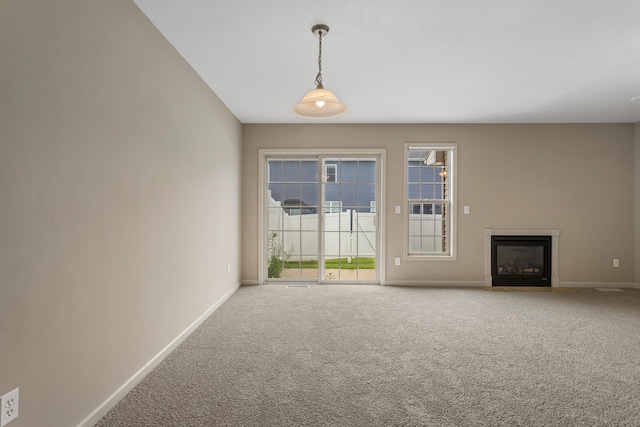 3418 Stoneway Ct, Champaign, IL 61822 - unfurnished living room featuring baseboards, carpet floors, and a glass covered fireplace