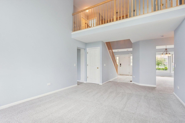 1173 Lamb Ln, Gurnee, IL 60031 - unfurnished living room with carpet floors, a high ceiling, and baseboards