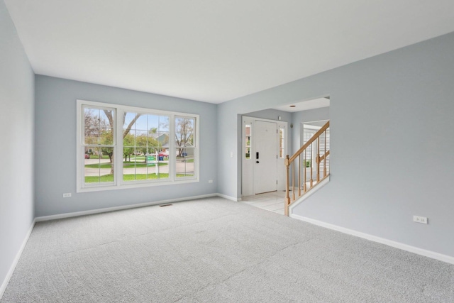 1173 Lamb Ln, Gurnee, IL 60031 - carpeted empty room featuring baseboards and stairs