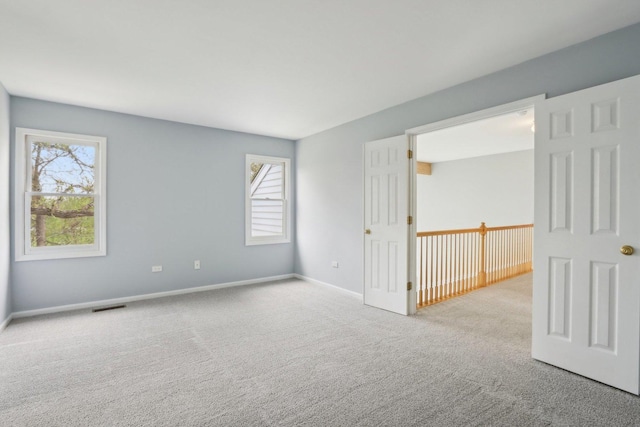 1173 Lamb Ln, Gurnee, IL 60031 - carpeted empty room featuring plenty of natural light and baseboards