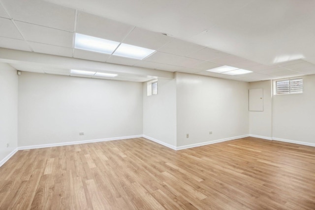 1173 Lamb Ln, Gurnee, IL 60031 - below grade area with light wood finished floors, baseboards, and a paneled ceiling