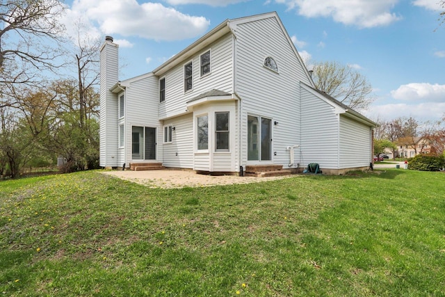 1173 Lamb Ln, Gurnee, IL 60031 - back of house with a chimney, entry steps, and a yard