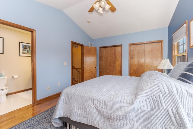 5 Tatiana Ct, Bloomington, IL 61704 - bedroom featuring wood finished floors, two closets, lofted ceiling, ensuite bath, and a ceiling fan