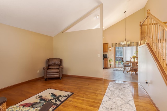 5 Tatiana Ct, Bloomington, IL 61704 - unfurnished room with a chandelier, high vaulted ceiling, light wood finished floors, and stairway