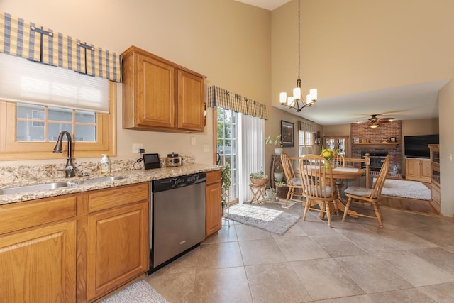 5 Tatiana Ct, Bloomington, IL 61704 - kitchen with dishwasher, a towering ceiling, a chandelier, a fireplace, and light stone countertops