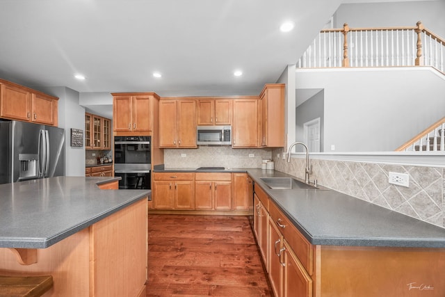 13825 Trillium Ln, Plainfield, IL 60544 - kitchen with a sink, stainless steel appliances, dark wood-type flooring, dark countertops, and recessed lighting