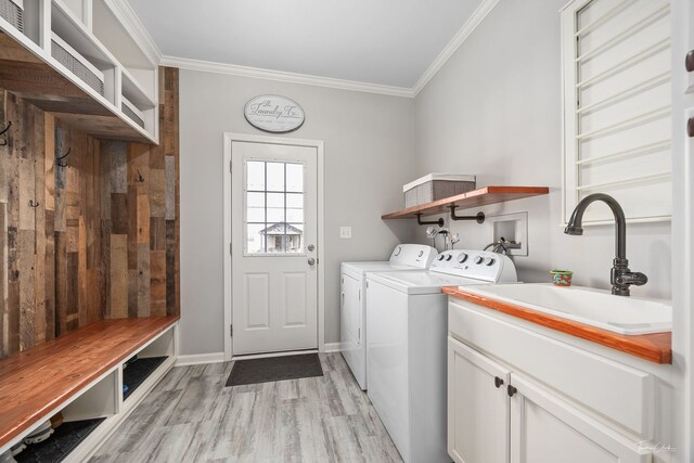 13825 Trillium Ln, Plainfield, IL 60544 - washroom with separate washer and dryer, ornamental molding, light wood-style floors, cabinet space, and baseboards