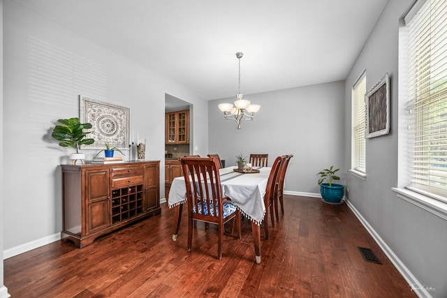 13825 Trillium Ln, Plainfield, IL 60544 - dining room featuring dark wood-type flooring, a chandelier, and baseboards