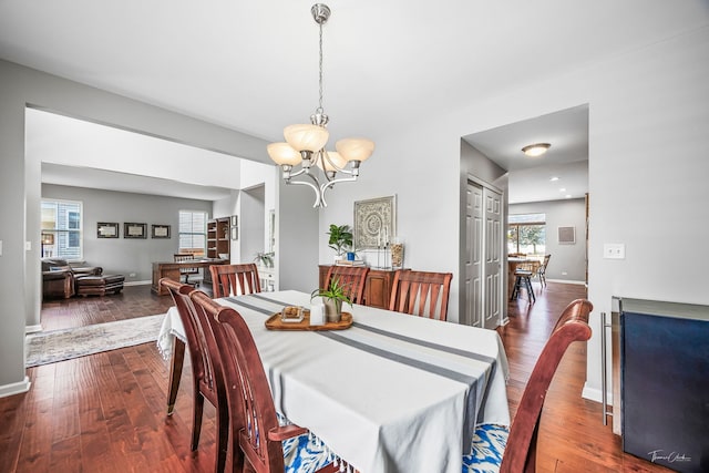13825 Trillium Ln, Plainfield, IL 60544 - dining area featuring a chandelier, dark wood-style floors, and baseboards