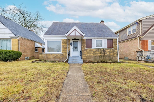 21 165th St, Calumet City, IL 60409 - view of front of house with a front lawn, brick siding, and a chimney